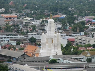 Phetchaburi: de witte prang van Wat Mahathat Worawihan boven de daken van Phetchaburi